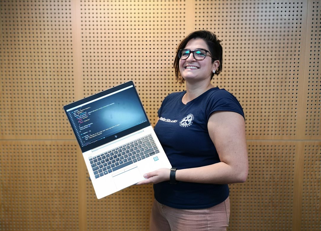 Photo of Carine holding a Laptop