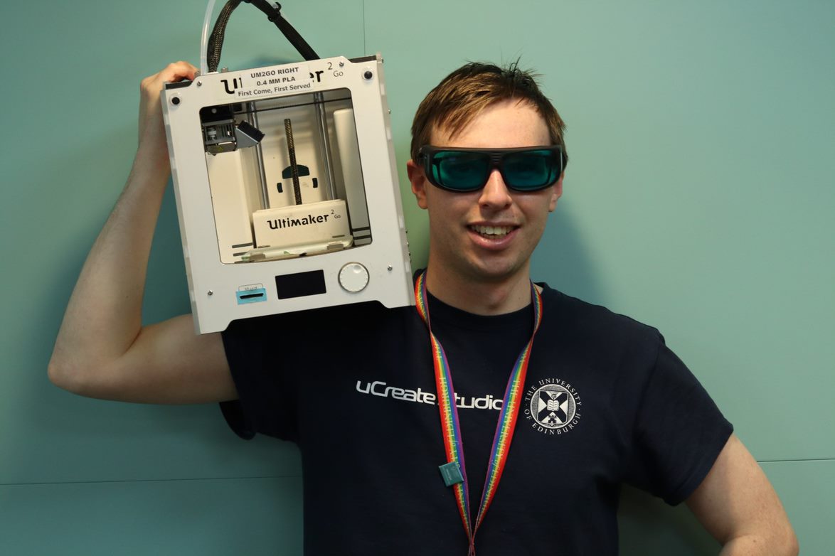 Photo of Anthony holding a 3D printer